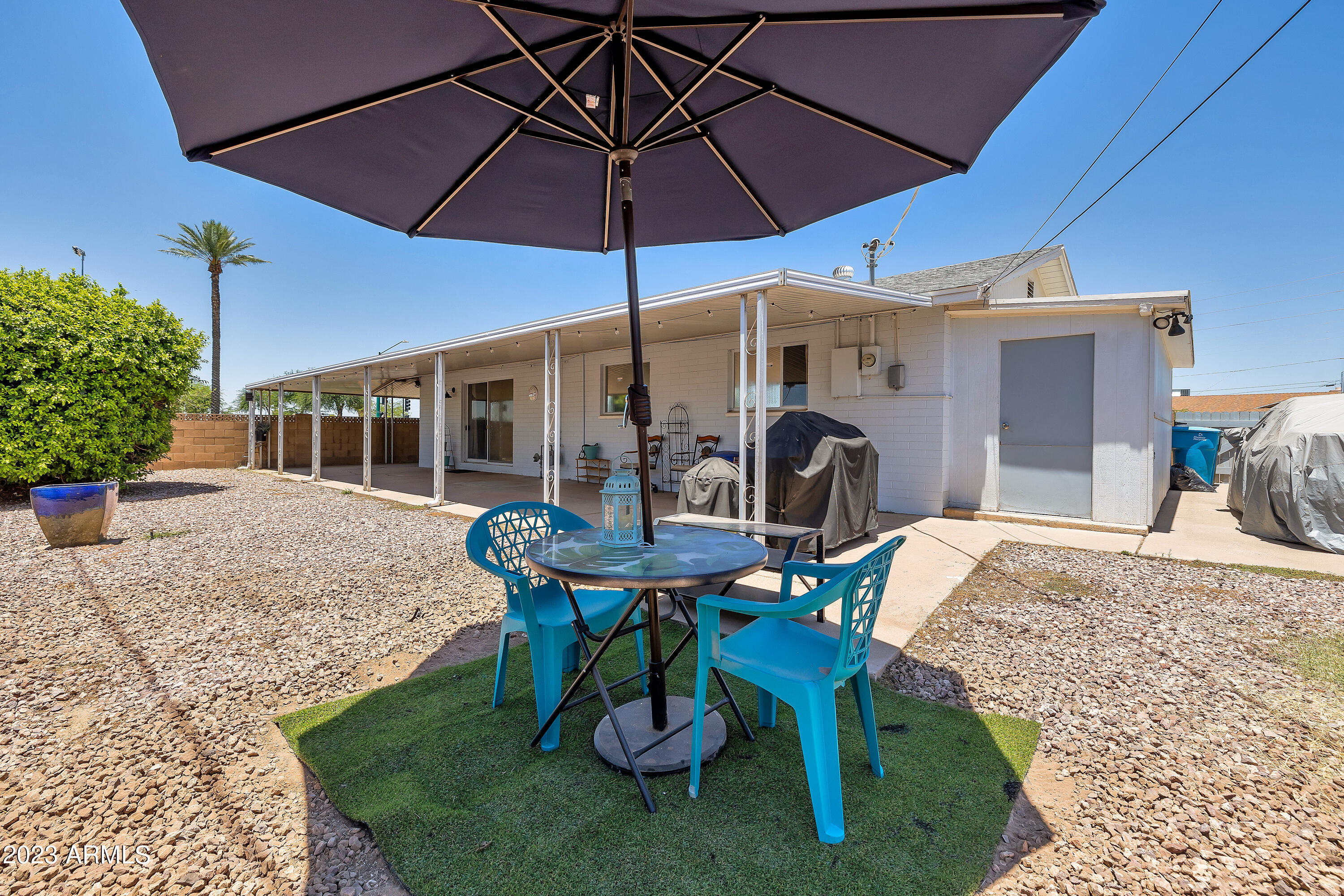 5473 West Osborn Road Phoenix, AZ 85031 - Photo 36 of 37 a view of a patio with a table and chairs under an umbrella