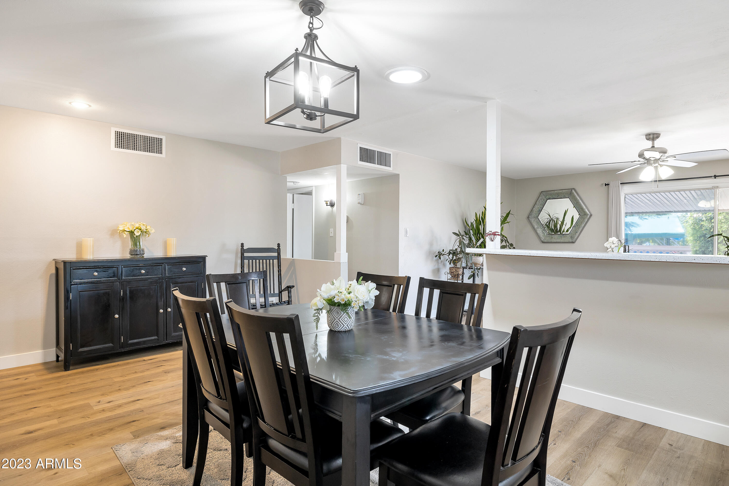 5473 West Osborn Road Phoenix, AZ 85031 - Photo 5 of 37 a view of a dining room with furniture and wooden floor