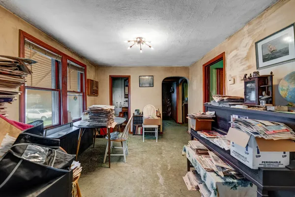 a living room with furniture a piano and a flat screen tv