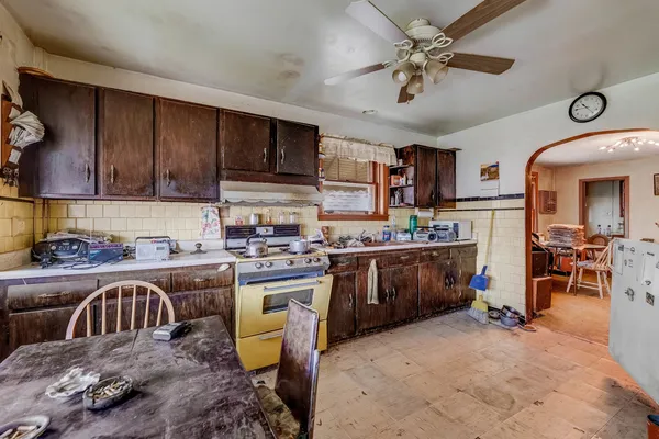 a kitchen that has a lot of cabinets in it and appliances