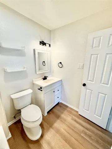 a white toilet sitting next to a bathroom sink