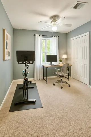 a view of a livingroom with workspace and a window