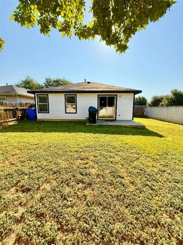 a view of a house with pool and a yard