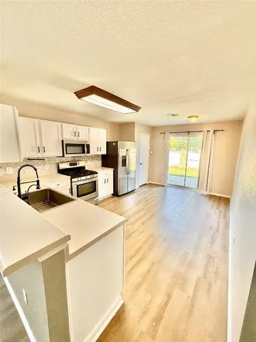 a view of a kitchen with furniture and a window