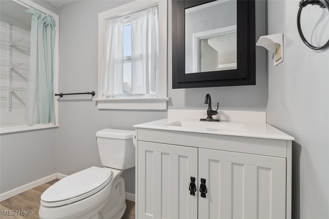 1853 Sylvan Road Wooster, OH 44691 - Photo 14 of 37 Bathroom with vanity and wood finished floors
