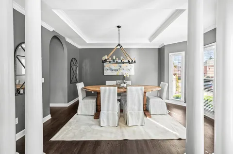 a living room with furniture fireplace and a large window