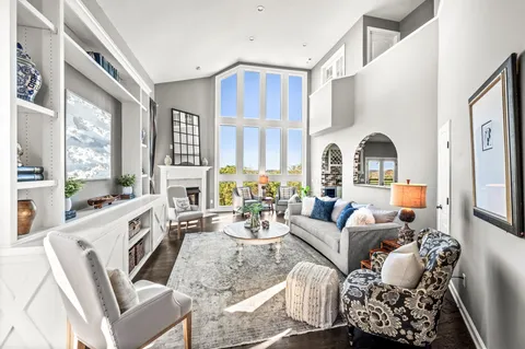 a bathroom with granite countertop white cabinets and a sink