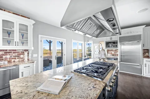 a spacious bedroom with a bed and a chandelier
