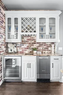 a spacious bedroom with a bed a chandelier and large window
