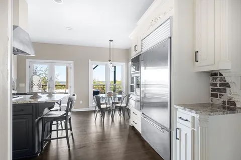 a living room with a couch and a dresser with wooden floor