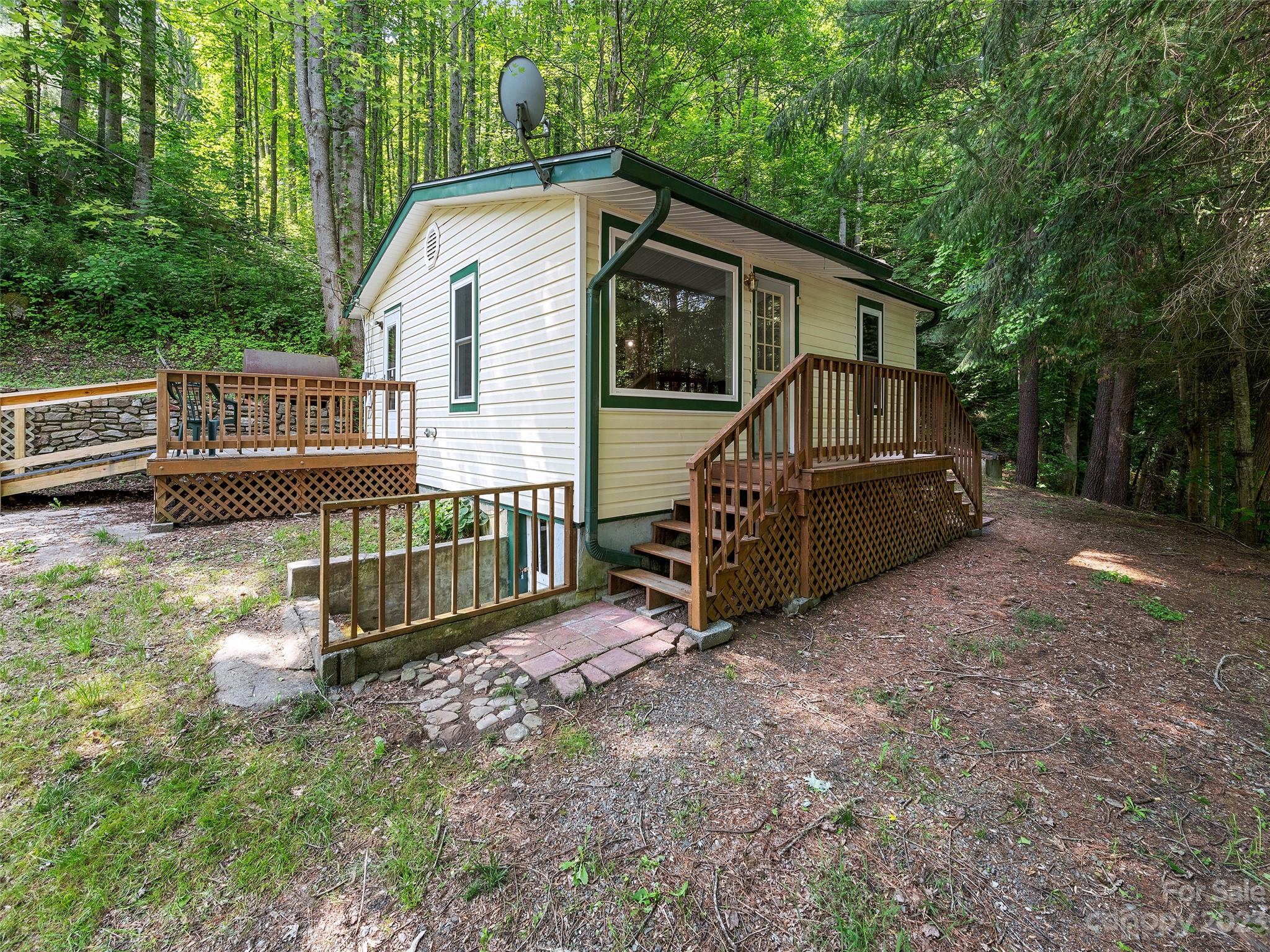 1053 Hall Top Road Waynesville, NC 28786 - Photo 3 of 27 a front view of a house with garden