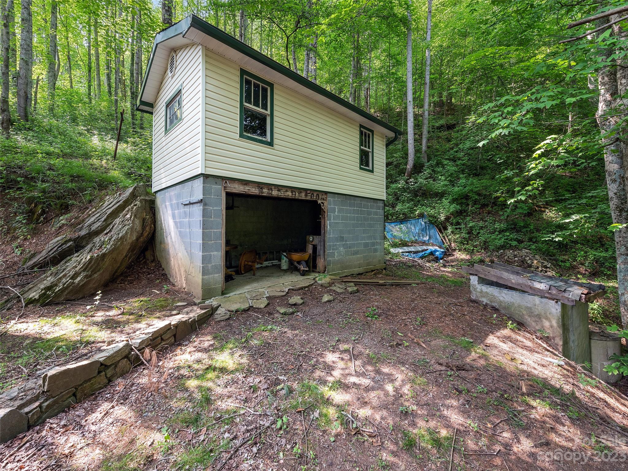 1053 Hall Top Road Waynesville, NC 28786 - Photo 6 of 27 a view of a house with backyard and garden