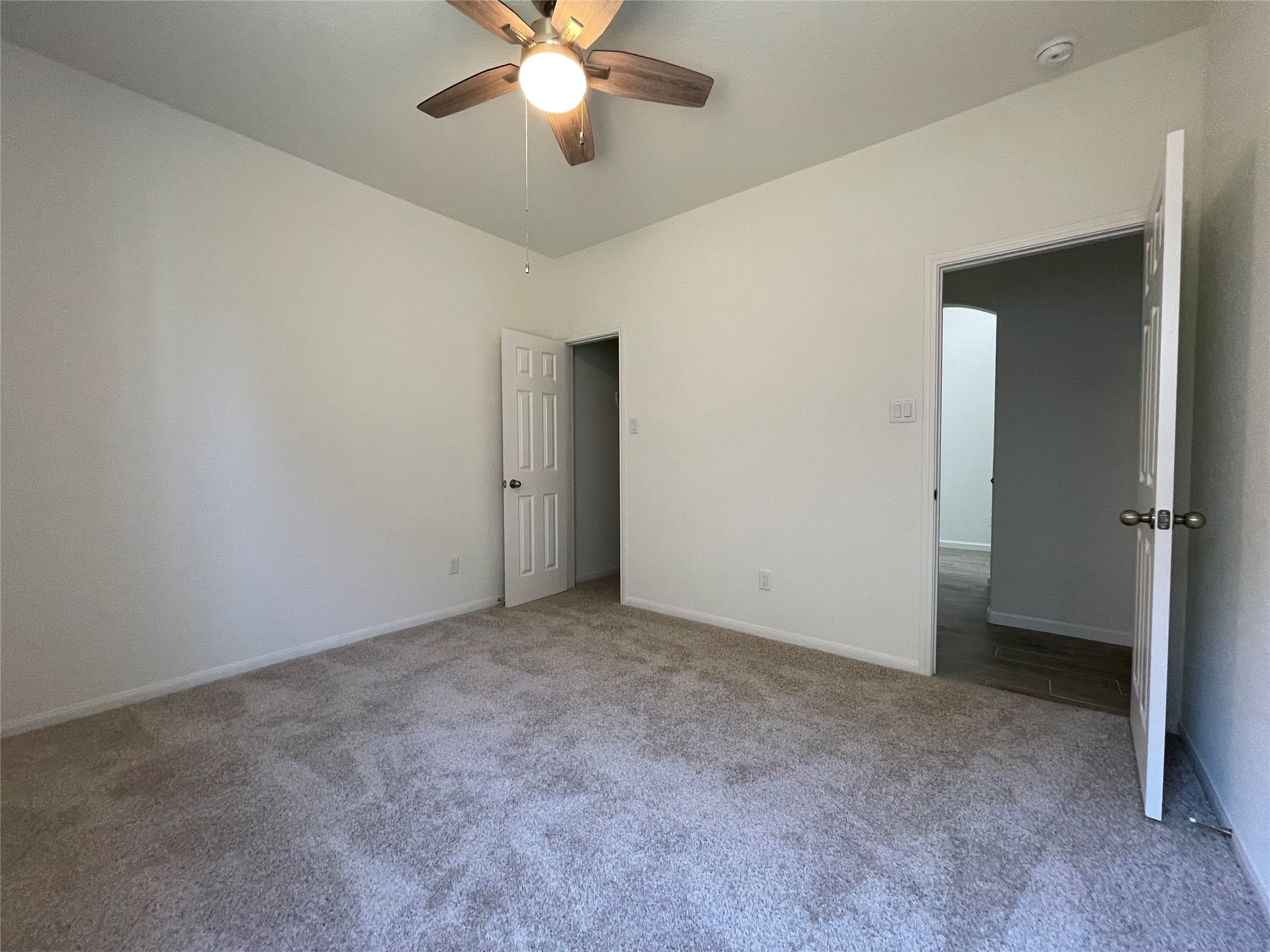 4118 Guild Meadows Drive Houston, TX 77084 - Photo 15 of 35 an empty room with a chandelier fan and a chandelier fan