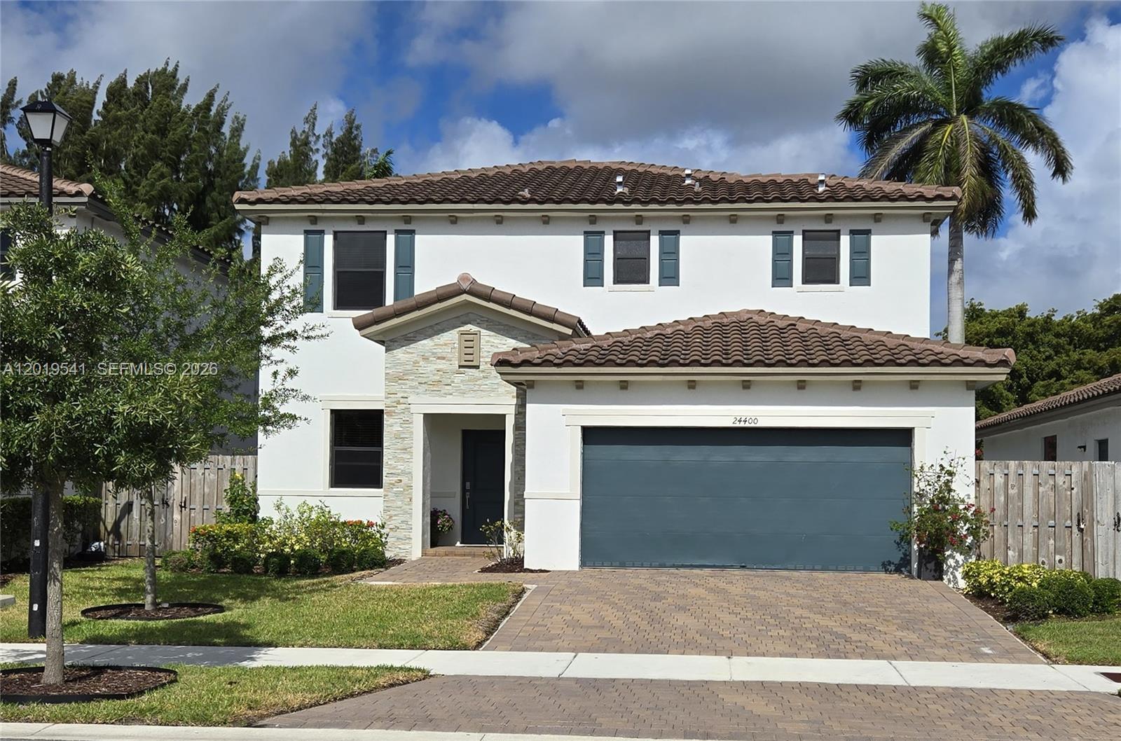 24400 Southwest 119th Place Homestead, FL 33032 - Photo 1 of 22 a front view of a house with a yard and garage