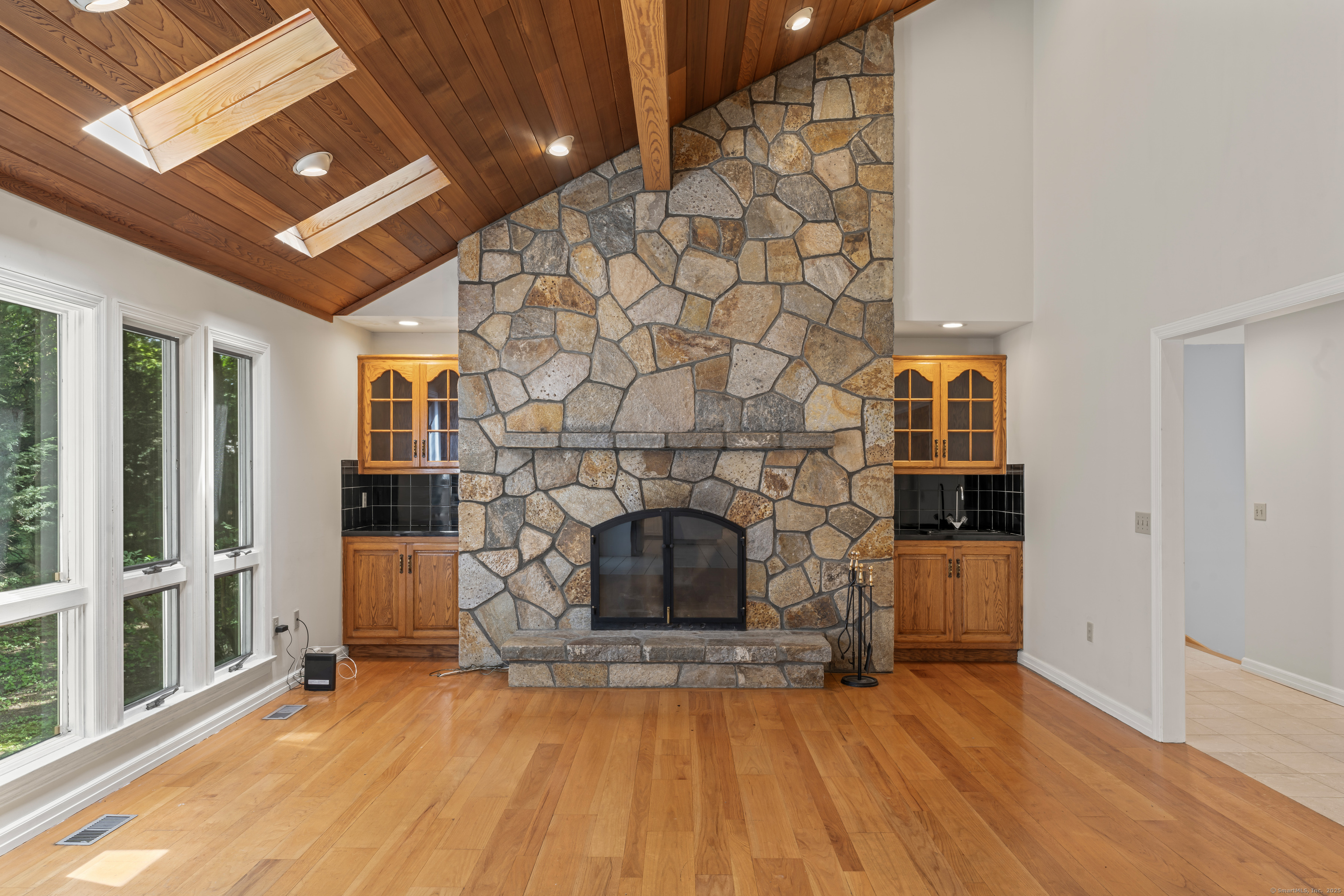501 Woodbine Road Stamford, CT 06903 - Photo 12 of 37 wooden floor fireplace and windows in an empty room