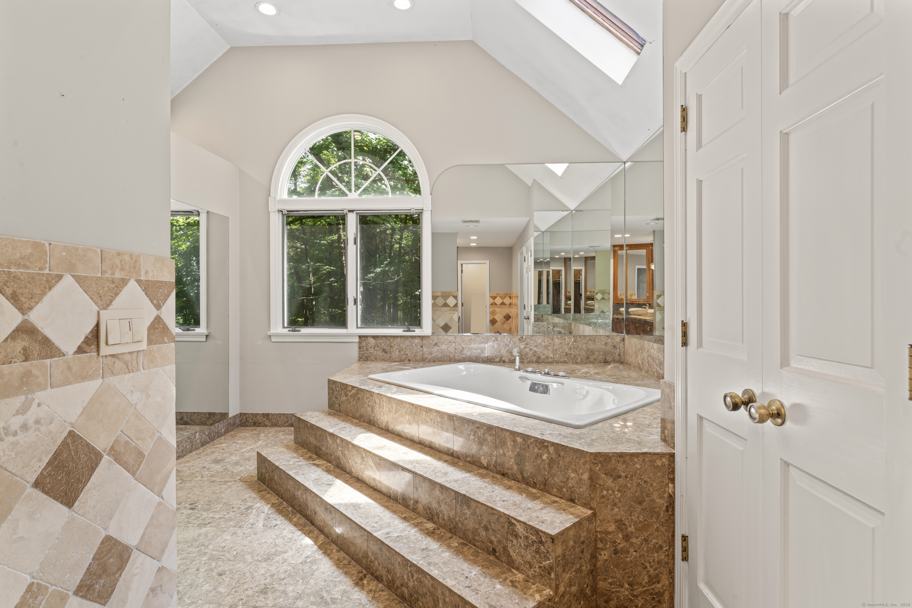 501 Woodbine Road Stamford, CT 06903 - Photo 14 of 37 a bathroom with a tub a sink and a large window