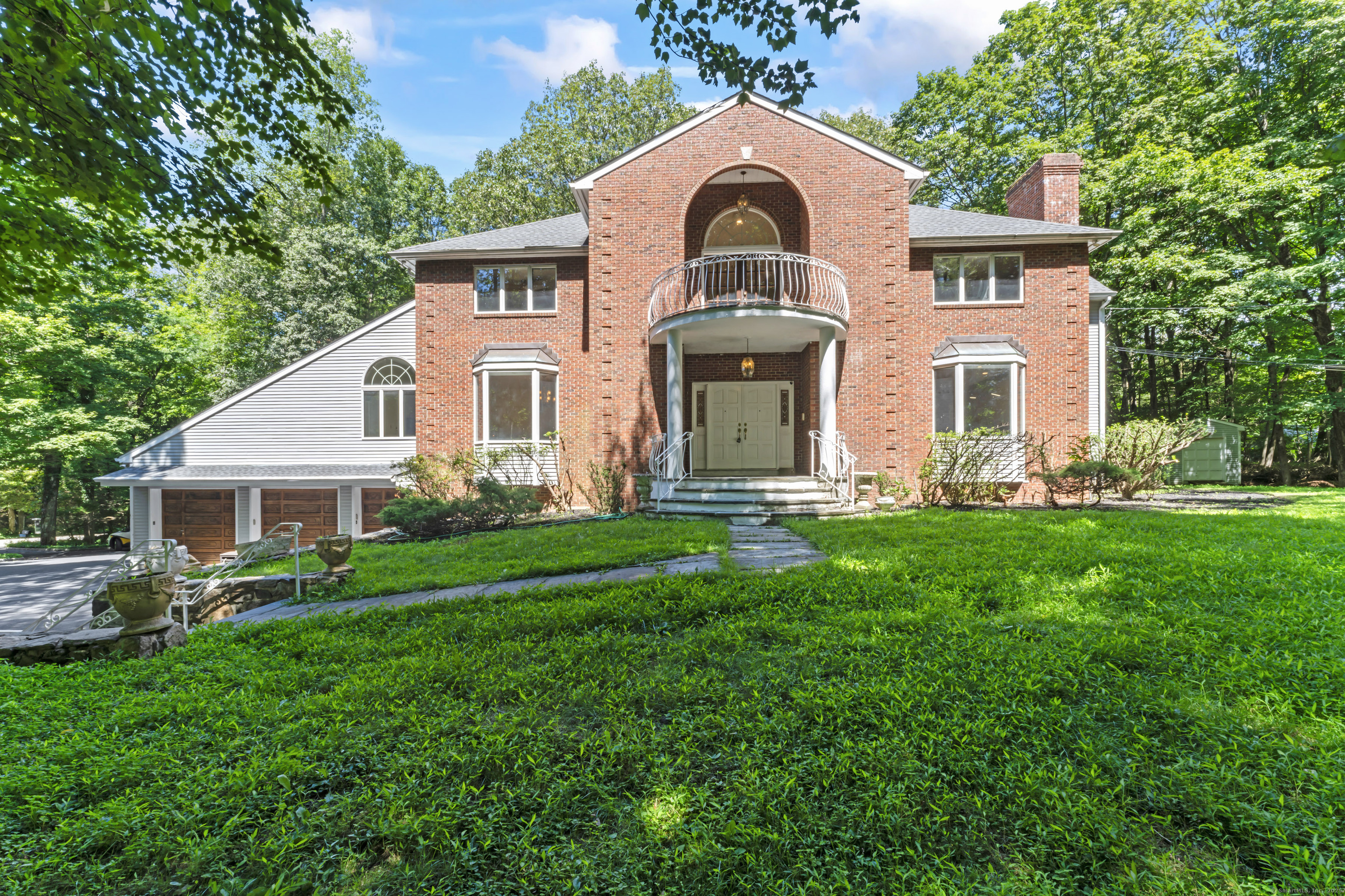 501 Woodbine Road Stamford, CT 06903 - Photo 22 of 37 a front view of a house with a garden and plants