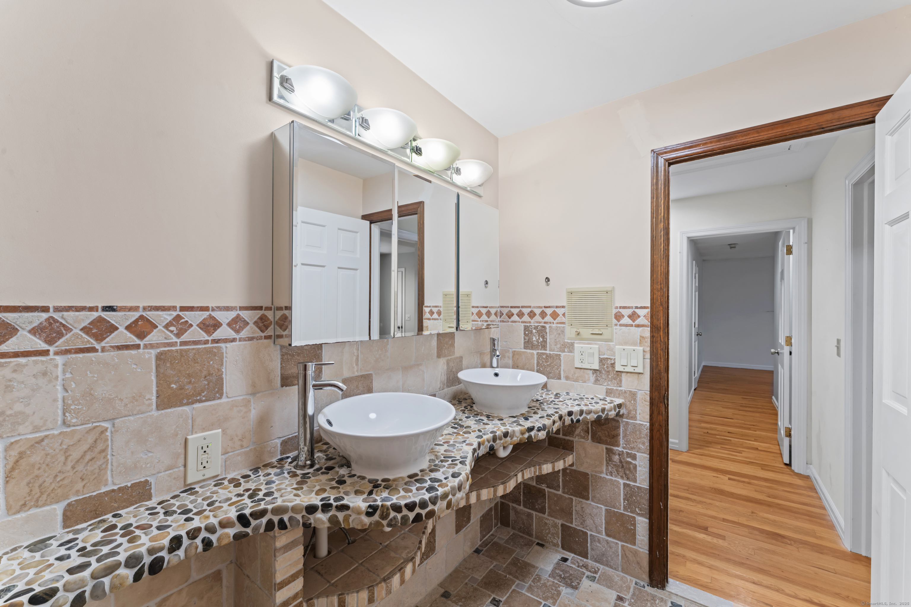 501 Woodbine Road Stamford, CT 06903 - Photo 31 of 37 a spacious bathroom with a double vanity sink and a mirror