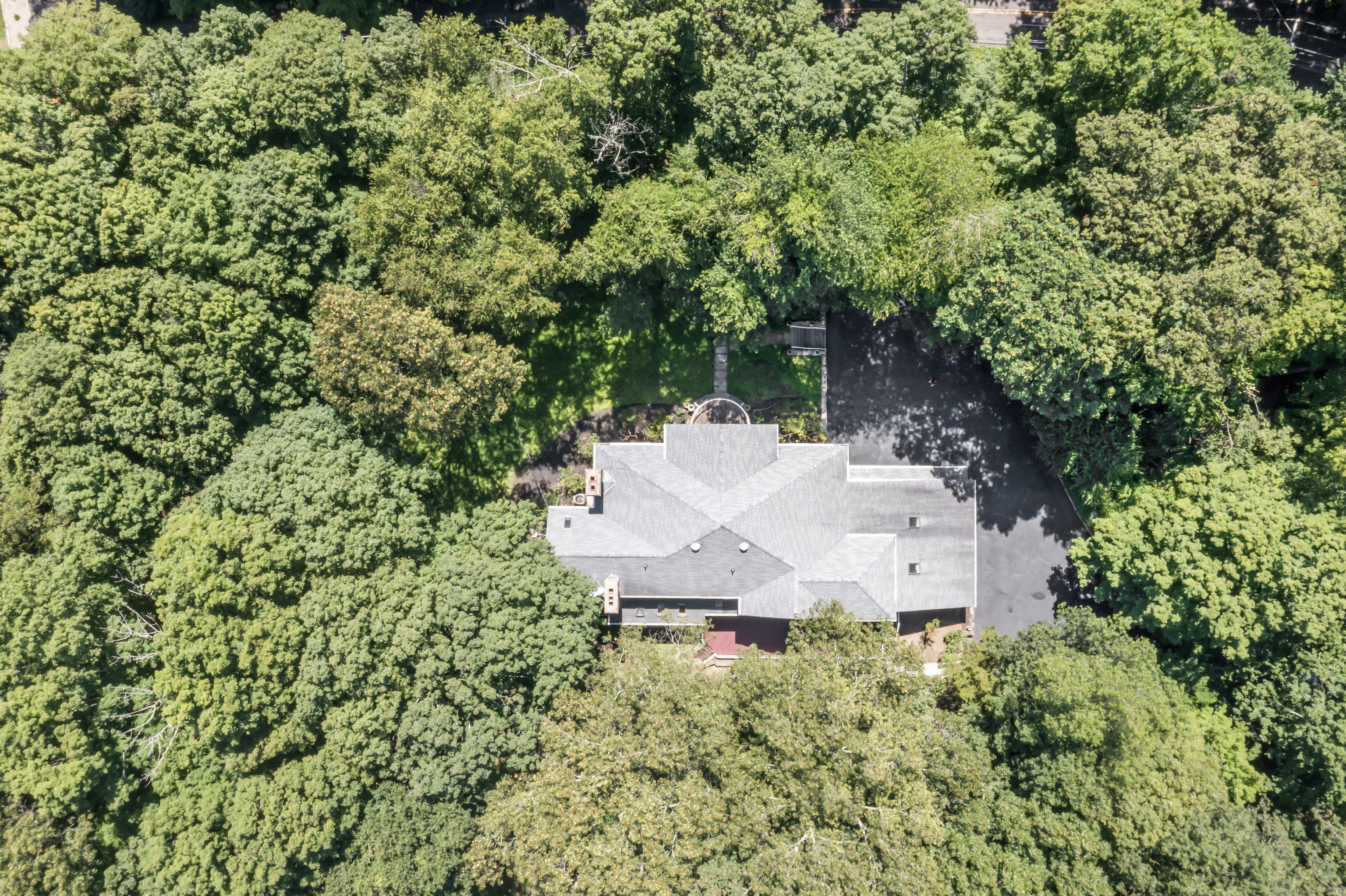 501 Woodbine Road Stamford, CT 06903 - Photo 32 of 37 an aerial view of a house with a yard and trees all around