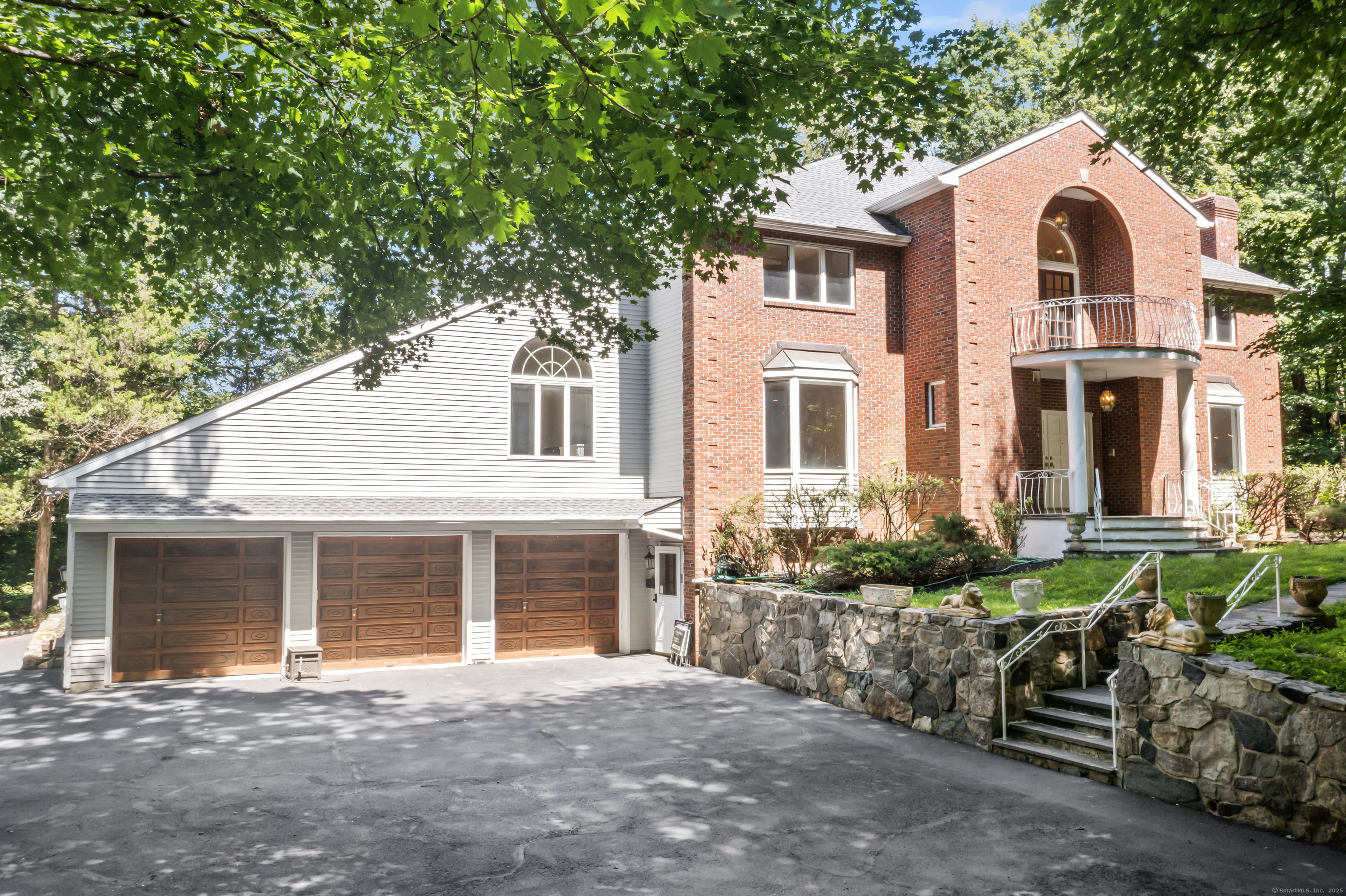 501 Woodbine Road Stamford, CT 06903 - Photo 33 of 37 a front view of a house with a garden
