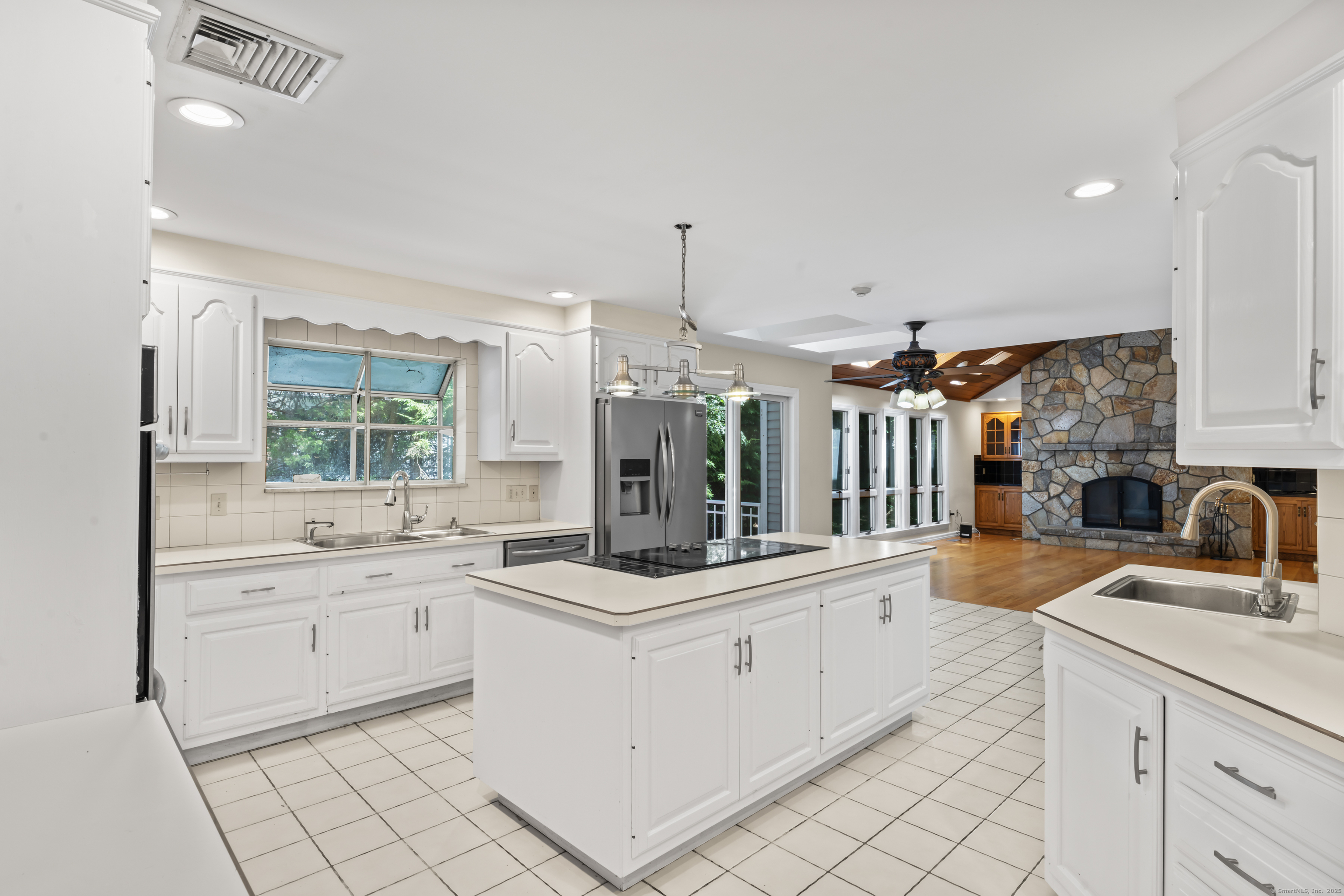 501 Woodbine Road Stamford, CT 06903 - Photo 4 of 37 a kitchen with sink cabinets and window