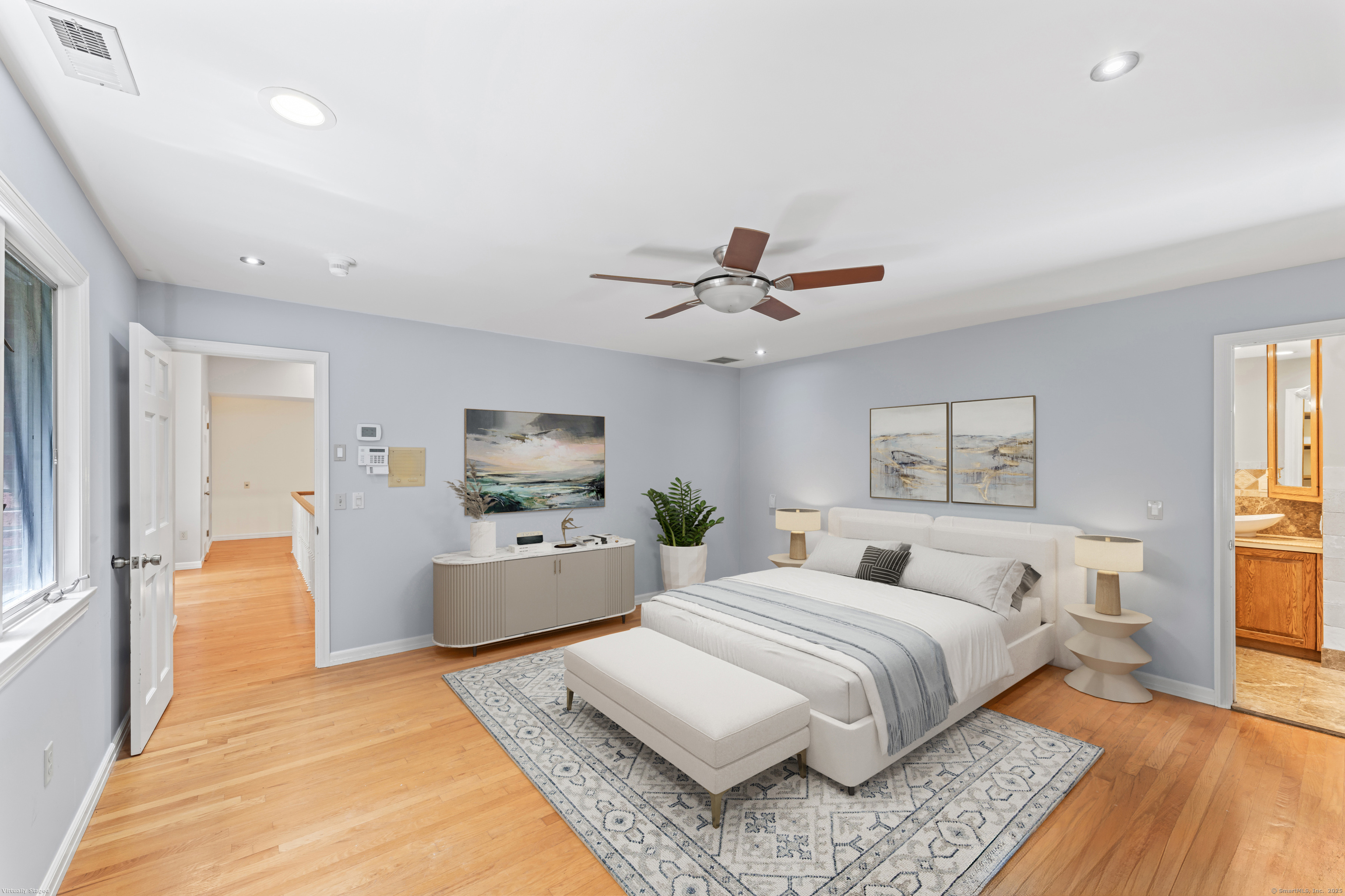 501 Woodbine Road Stamford, CT 06903 - Photo 10 of 37 a bedroom with a large bed and a chandelier