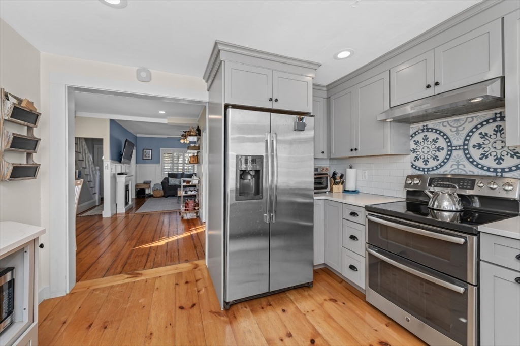 171 Coleridge Street Boston, MA 02128 - Photo 12 of 30 a kitchen with stainless steel appliances a refrigerator and a stove top oven