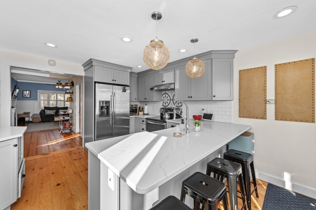 171 Coleridge Street Boston, MA 02128 - Photo 14 of 30 a kitchen with a table chairs and a refrigerator