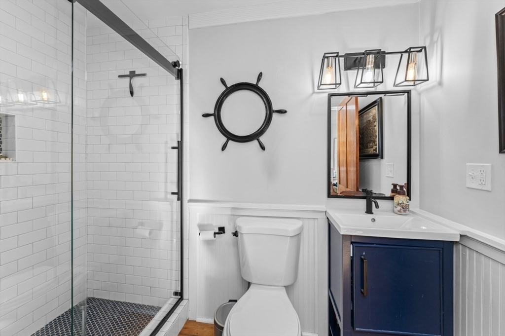 171 Coleridge Street Boston, MA 02128 - Photo 16 of 30 a bathroom with a sink a toilet and shower
