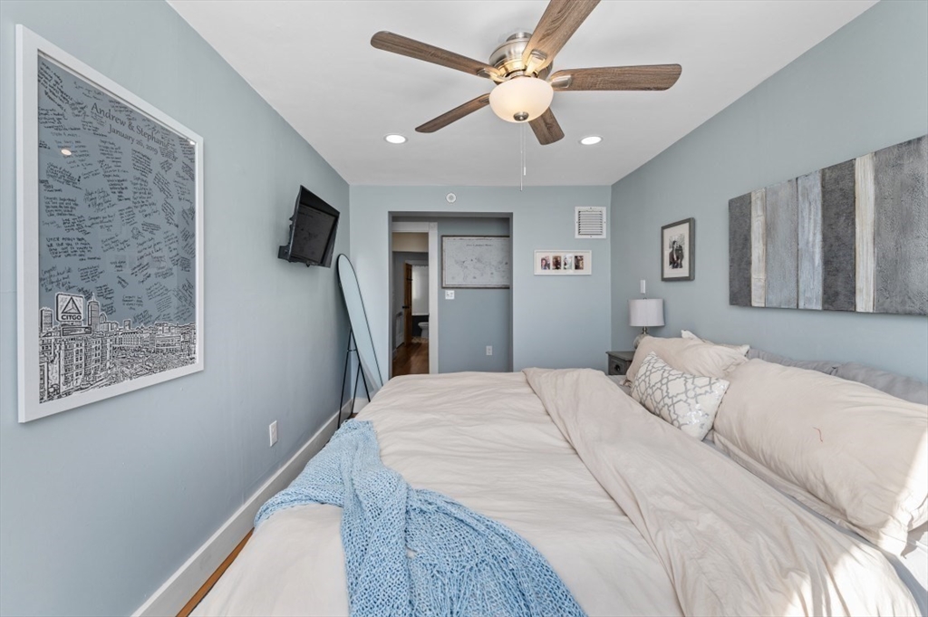 171 Coleridge Street Boston, MA 02128 - Photo 22 of 30 a bedroom with a large bed and a flat screen tv