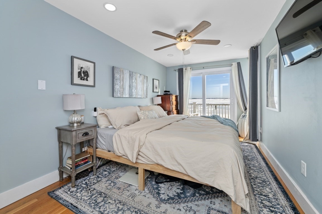 171 Coleridge Street Boston, MA 02128 - Photo 23 of 30 a bedroom with a large bed and a chandelier