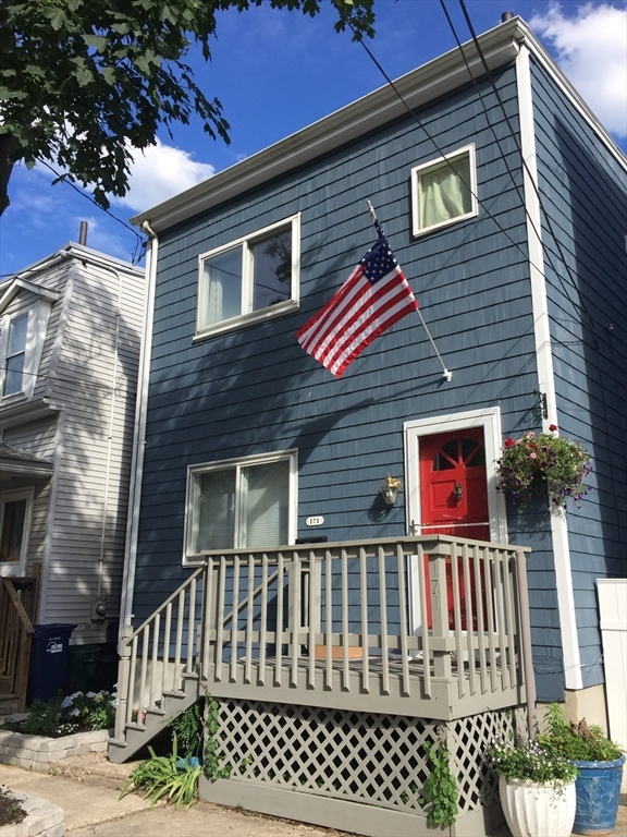 171 Coleridge Street Boston, MA 02128 - Photo 3 of 30 a view of a brick house with wooden fence