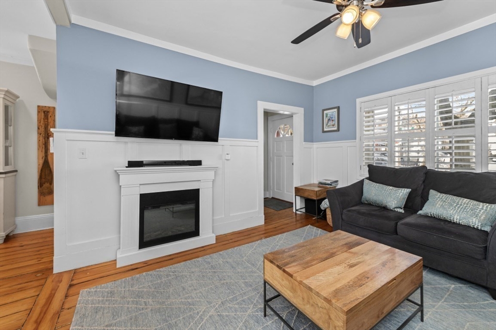 171 Coleridge Street Boston, MA 02128 - Photo 8 of 30 a living room with furniture a flat screen tv and a fireplace