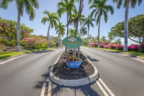 a vase of flowers sitting on a table with potted plants