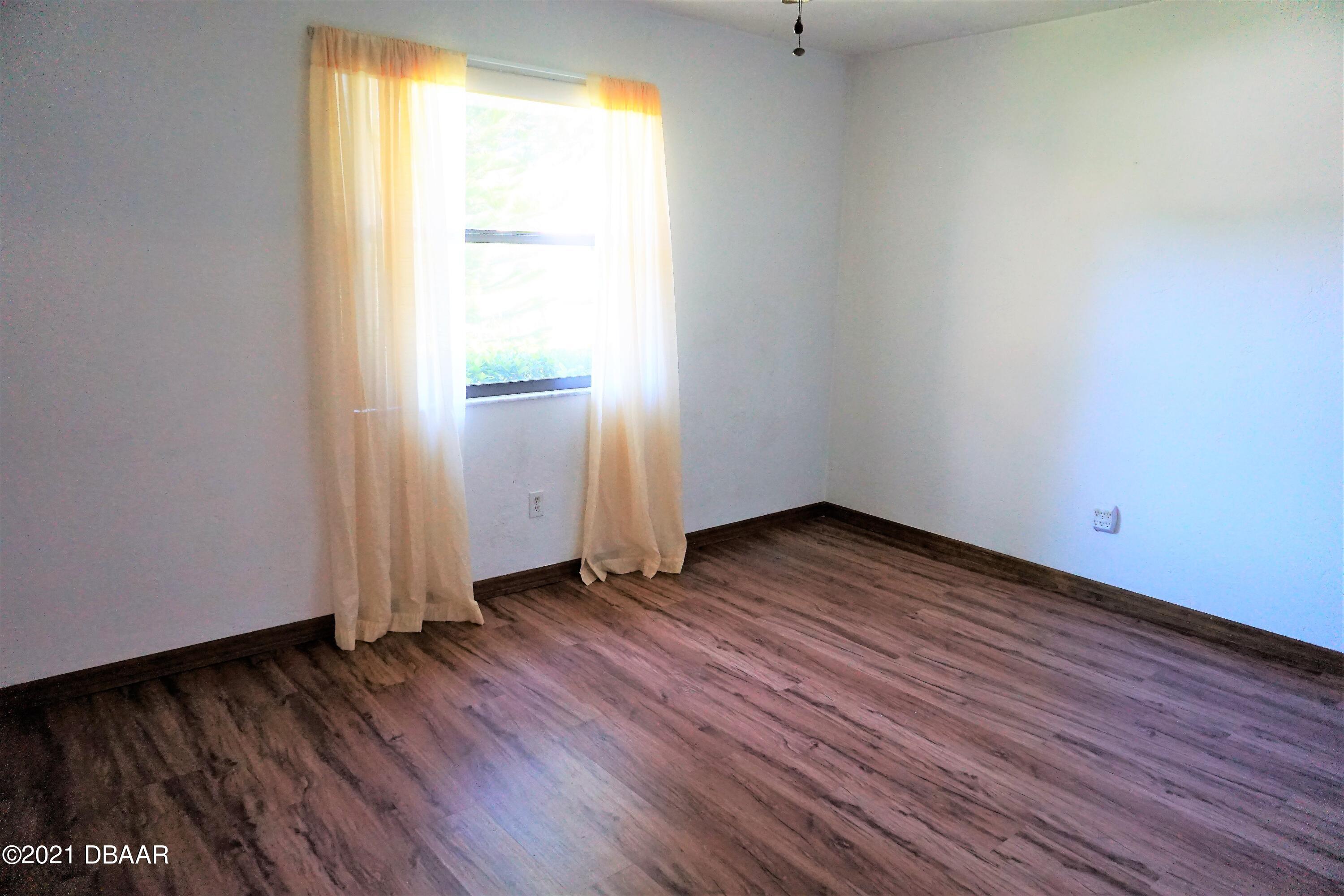 12 Charleston Square Ormond Beach, FL 32174 - Photo 14 of 26 a view of a room with wooden floor and window
