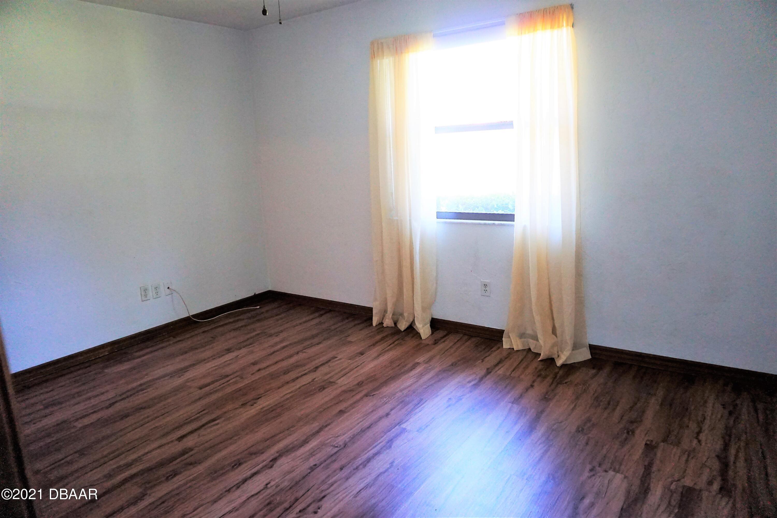 12 Charleston Square Ormond Beach, FL 32174 - Photo 15 of 26 a view of a room with wooden floor and window