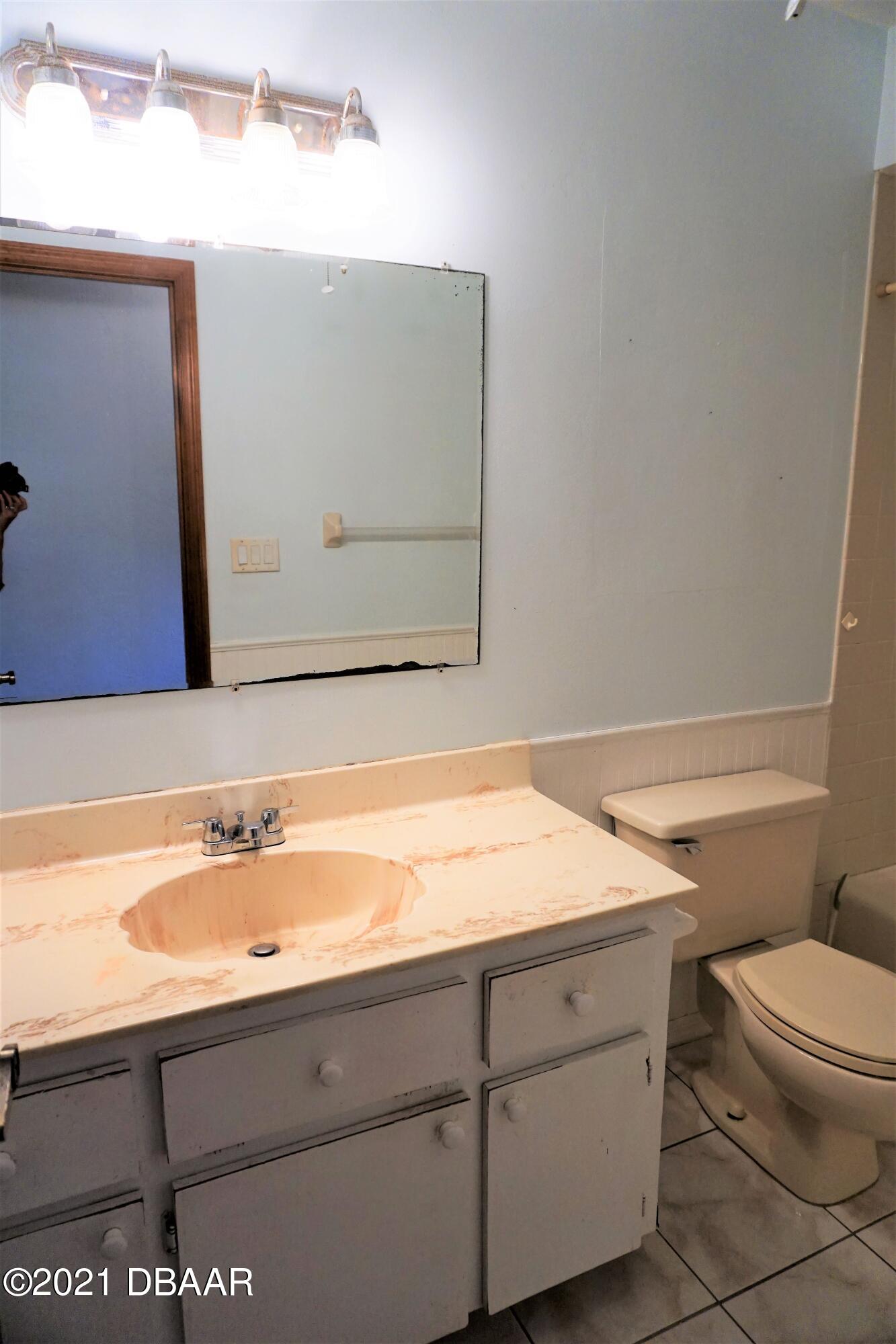 12 Charleston Square Ormond Beach, FL 32174 - Photo 20 of 26 a bathroom with a sink a toilet and mirror