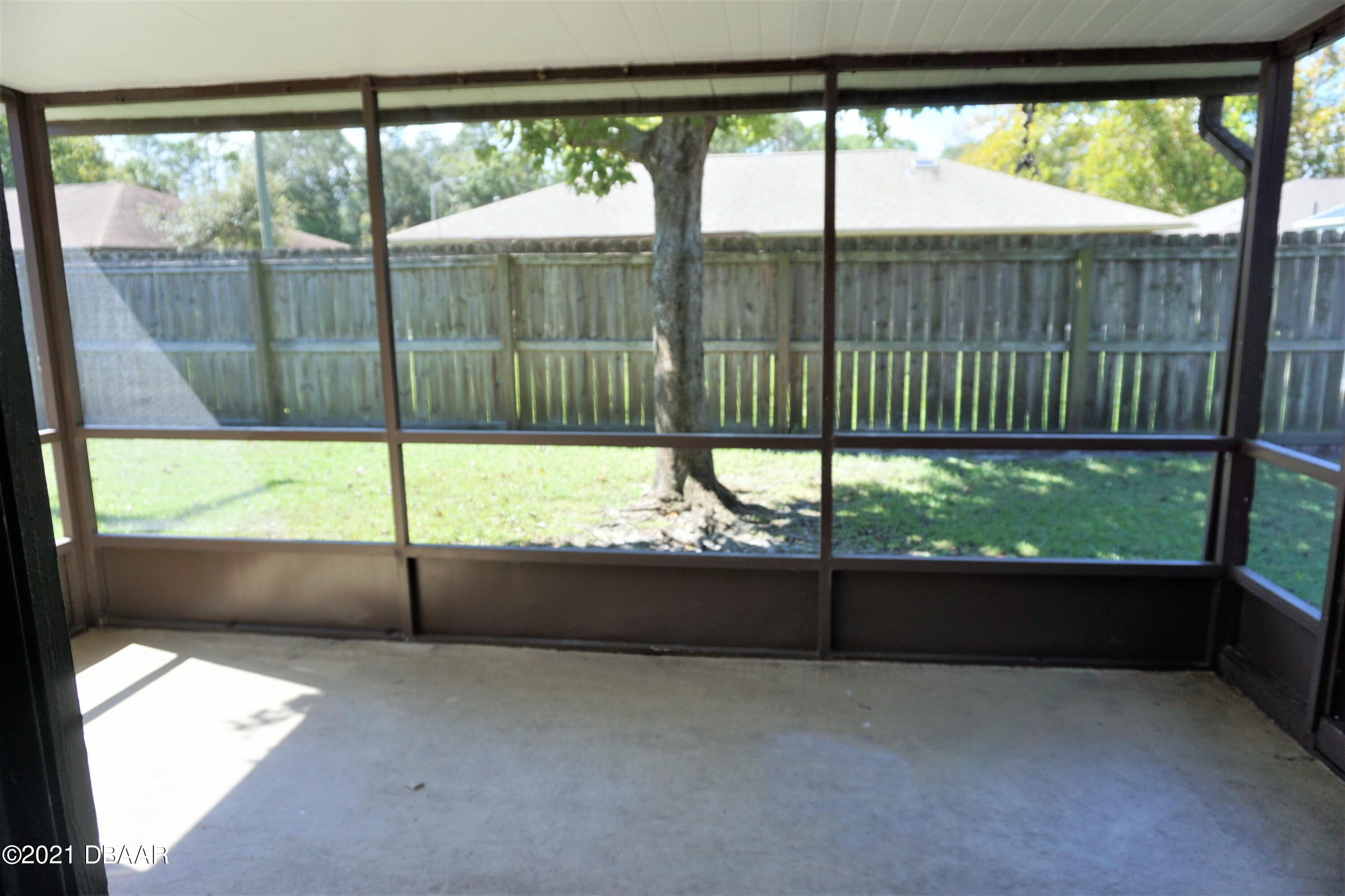 12 Charleston Square Ormond Beach, FL 32174 - Photo 21 of 26 a view of an empty room and floor to ceiling window