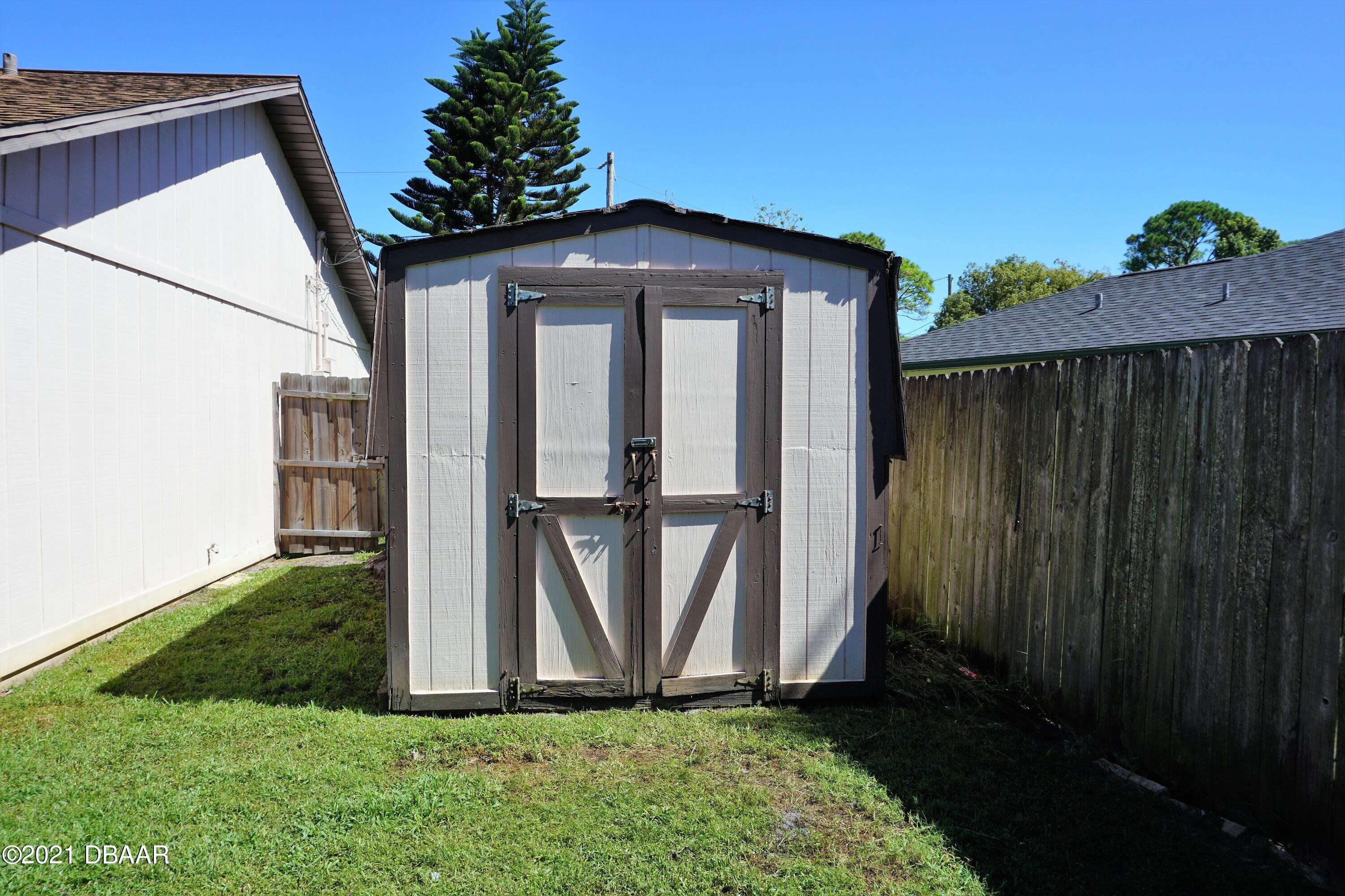12 Charleston Square Ormond Beach, FL 32174 - Photo 22 of 26 a view of a backyard with barn