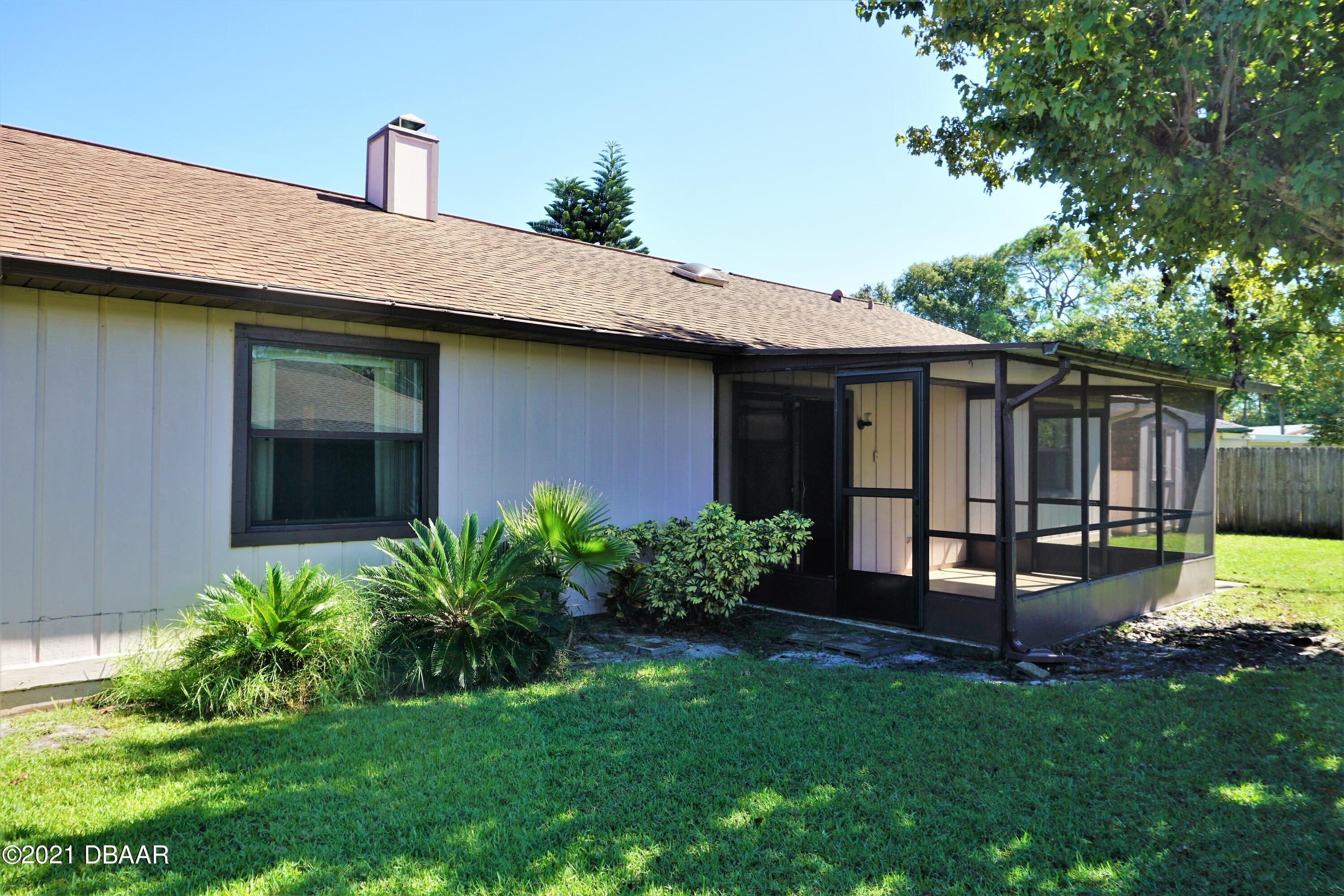 12 Charleston Square Ormond Beach, FL 32174 - Photo 24 of 26 a front view of a house with garden