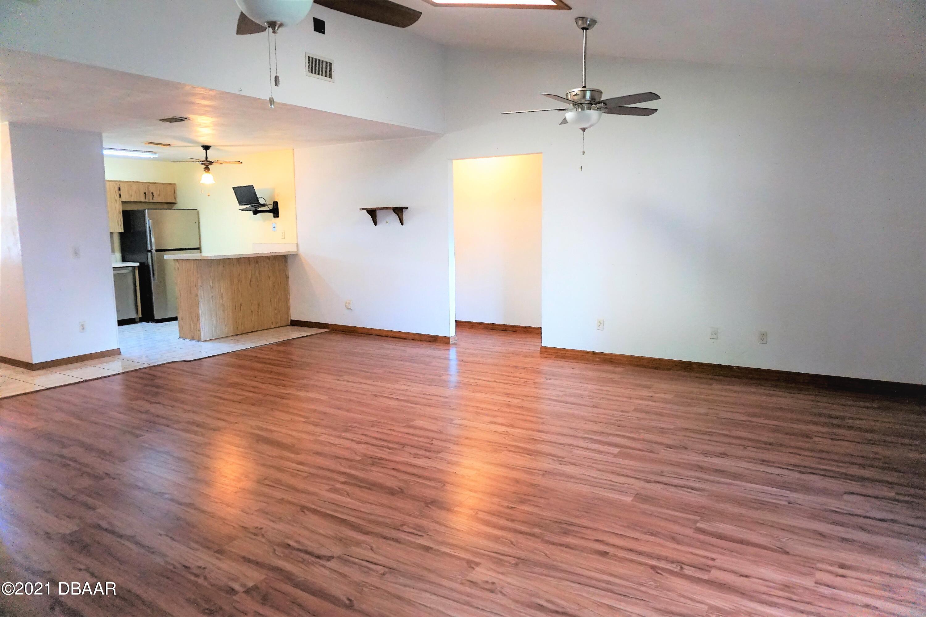 12 Charleston Square Ormond Beach, FL 32174 - Photo 5 of 26 a view of a kitchen with wooden floor and a kitchen space