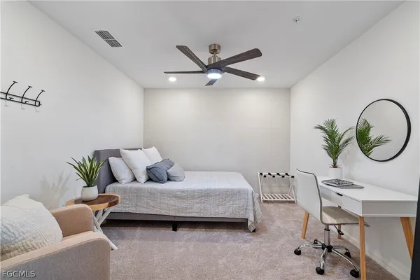 a living room with a couch and a chandelier