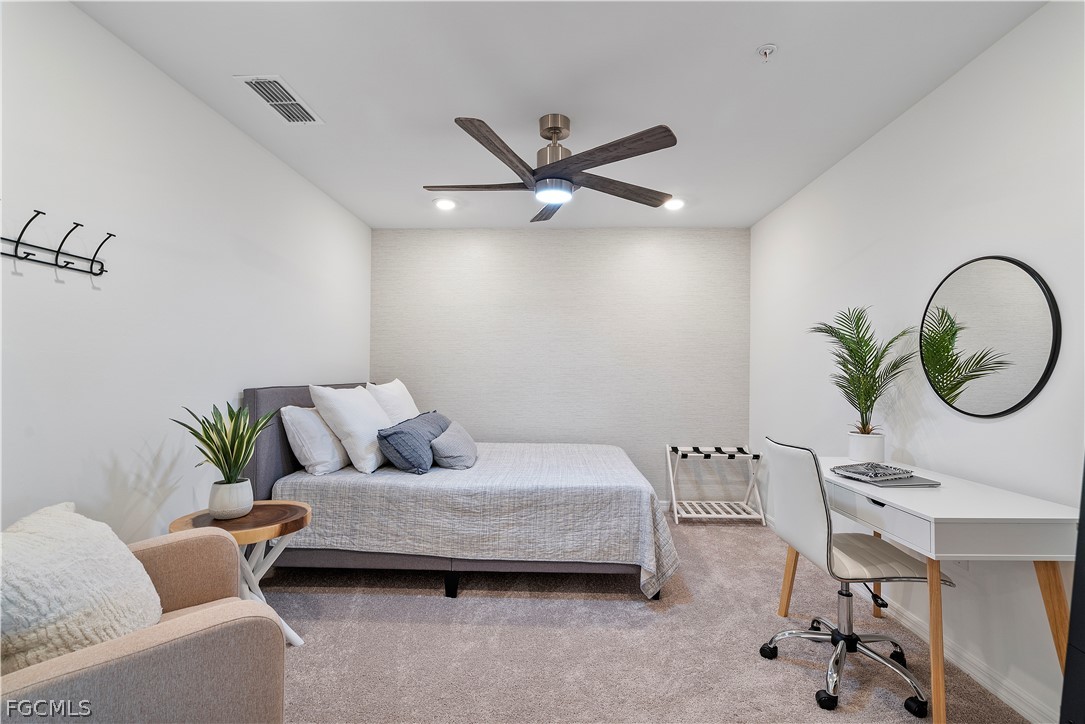 43996 Boardwalk Loop, Unit 1422 Punta Gorda, FL 33982 - Photo 12 of 37 a living room with a couch and a chandelier