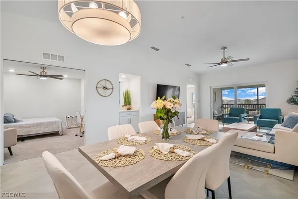 a dining room with furniture a rug and a mirror