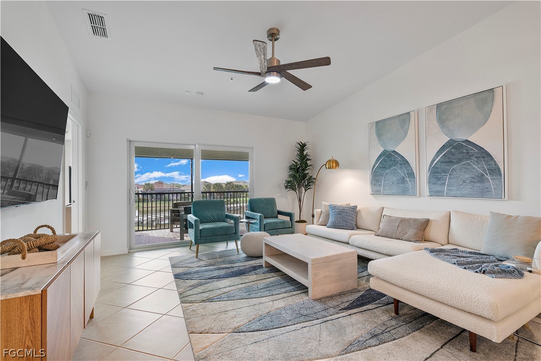 43996 Boardwalk Loop, Unit 1422 Punta Gorda, FL 33982 - Photo 15 of 37 a living room with furniture and a flat screen tv