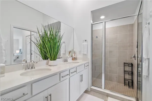 a bathroom with double vanity sink and a mirror