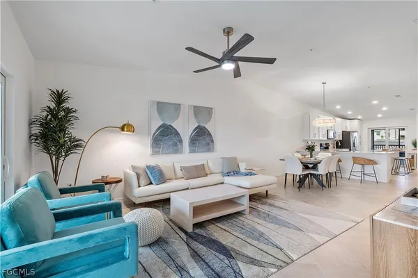 a living room with furniture and a chandelier