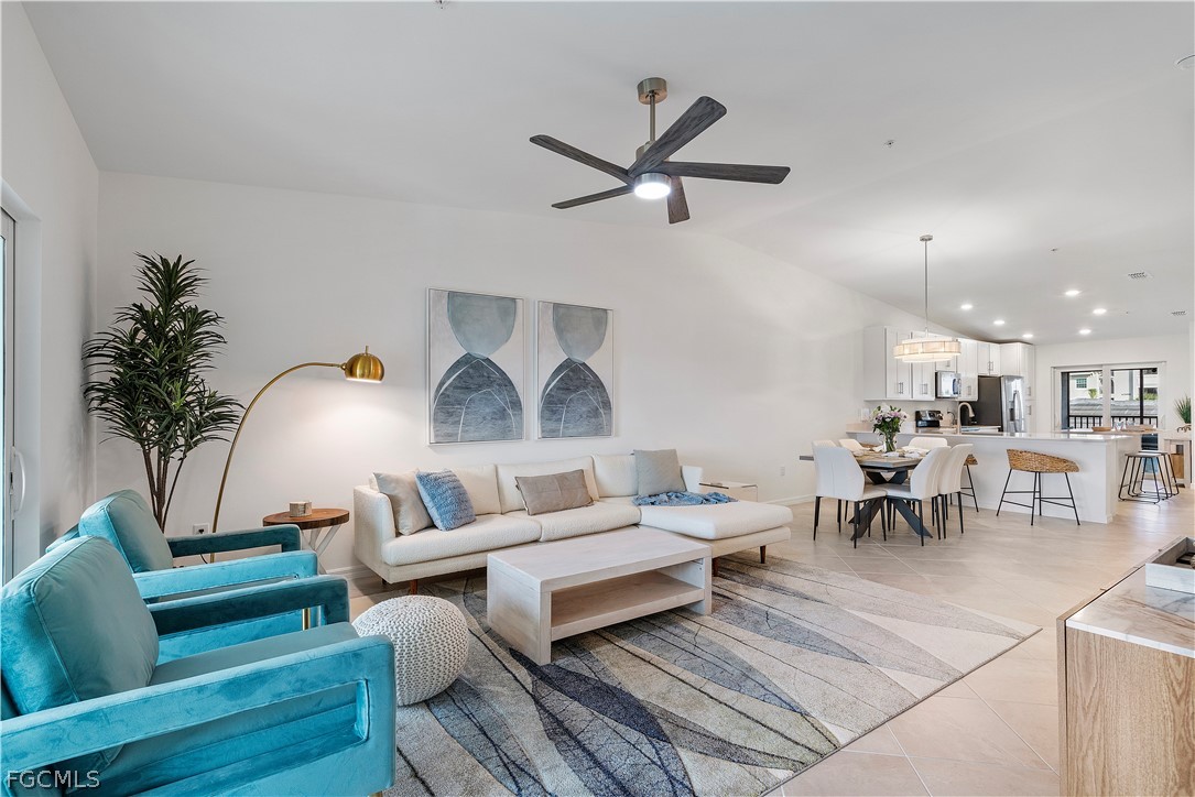 43996 Boardwalk Loop, Unit 1422 Punta Gorda, FL 33982 - Photo 21 of 37 a living room with furniture and a chandelier