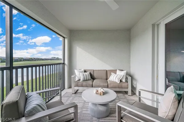 a living room with furniture and a large window