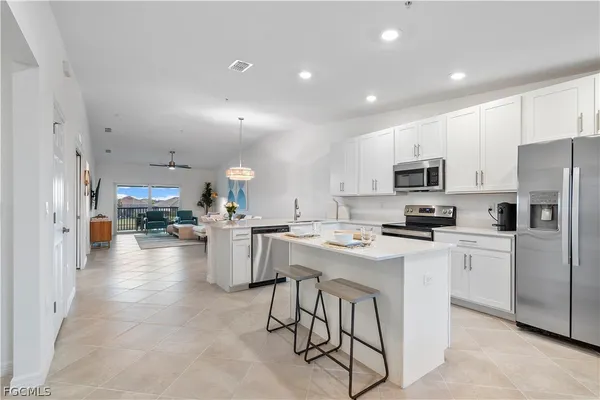 a kitchen with refrigerator and cabinets